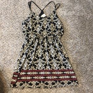 Black and cream colored sundress with red accents